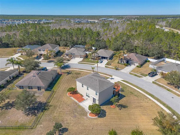 an aerial view of a house with outdoor space