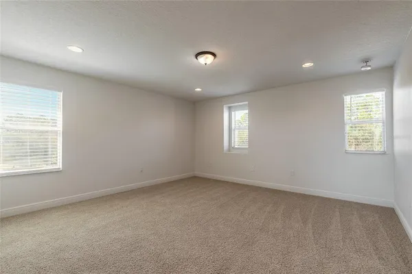 a spacious bedroom with a bed and furniture