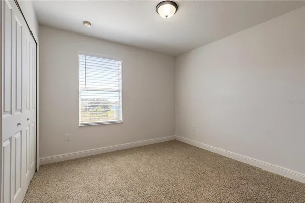a bedroom with a bed couch and window