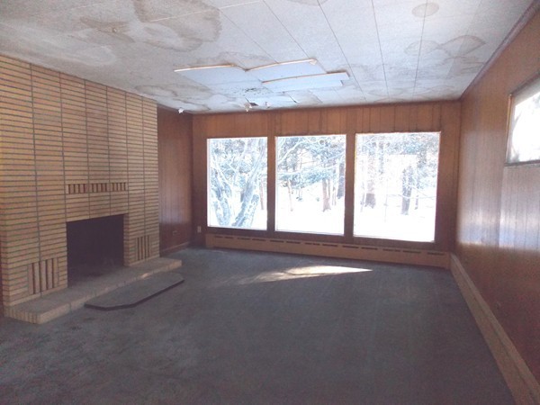 197 Littleton Road Harvard, MA 01451 - Photo 4 of 9 a view of an empty room with a fireplace and a window