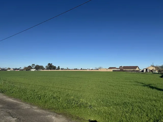 a view of a field with an ocean view