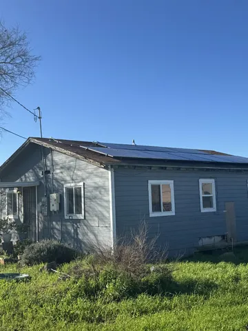 a view of a brick house with a yard