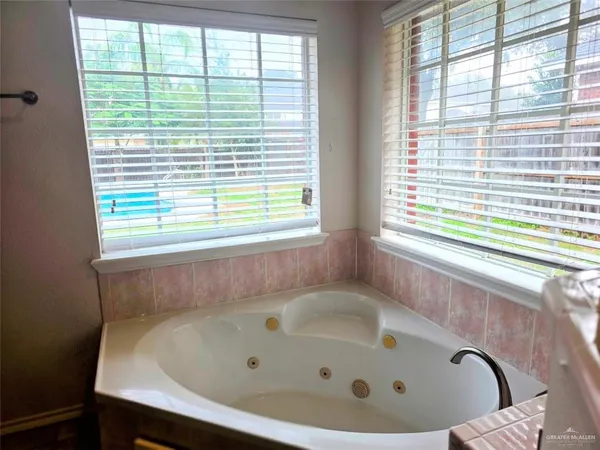 a bath tub sitting in a bathroom next to a window