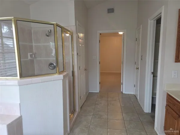 a bathroom with a shower and closet