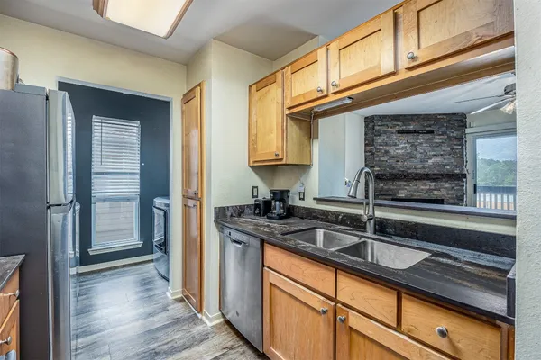 a bathroom with a granite countertop toilet sink and mirror