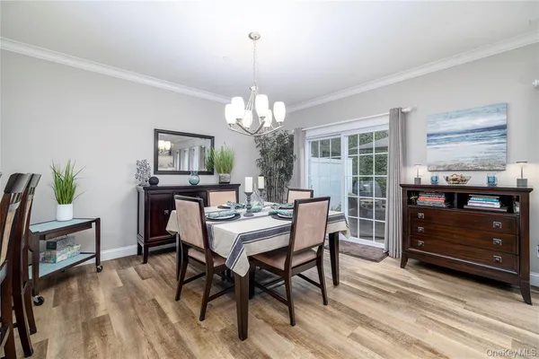 a view of a dining room with furniture and a chandelier