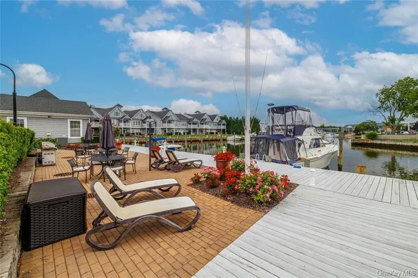 a view of a rooftop deck with couch and chairs