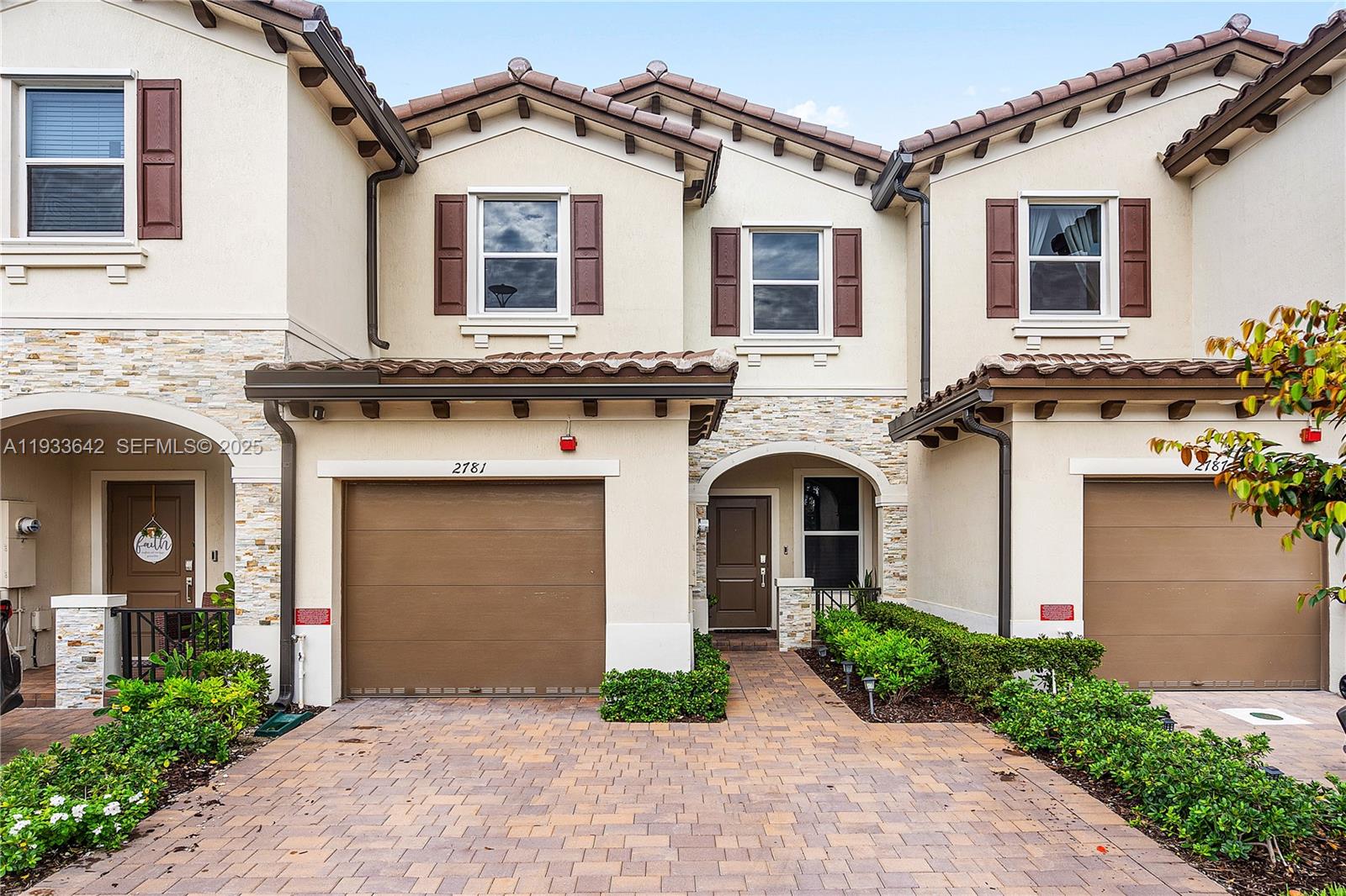 a front view of a house with garden