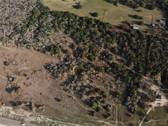 a view of a dry yard with trees