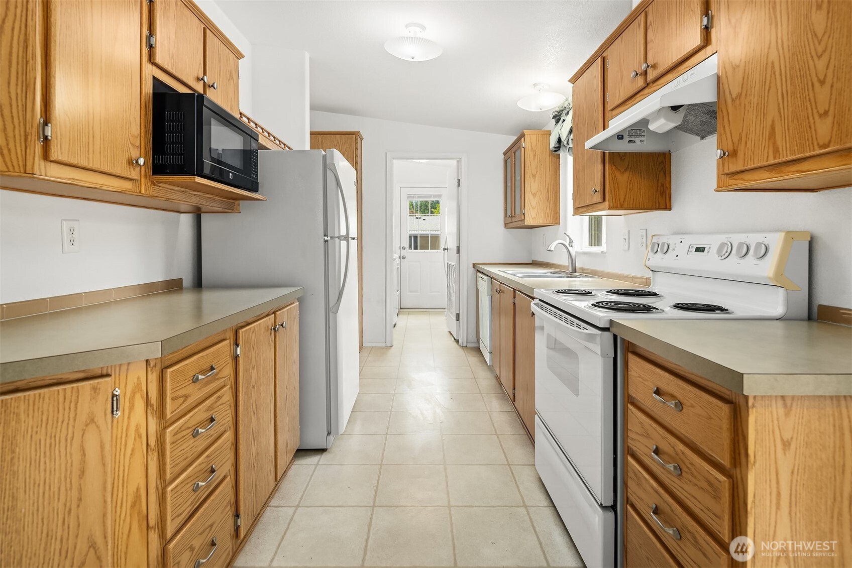 3222 206th Place Southeast Bothell, WA 98012 - Photo 9 of 32 a kitchen with stainless steel appliances granite countertop a stove a sink and a microwave