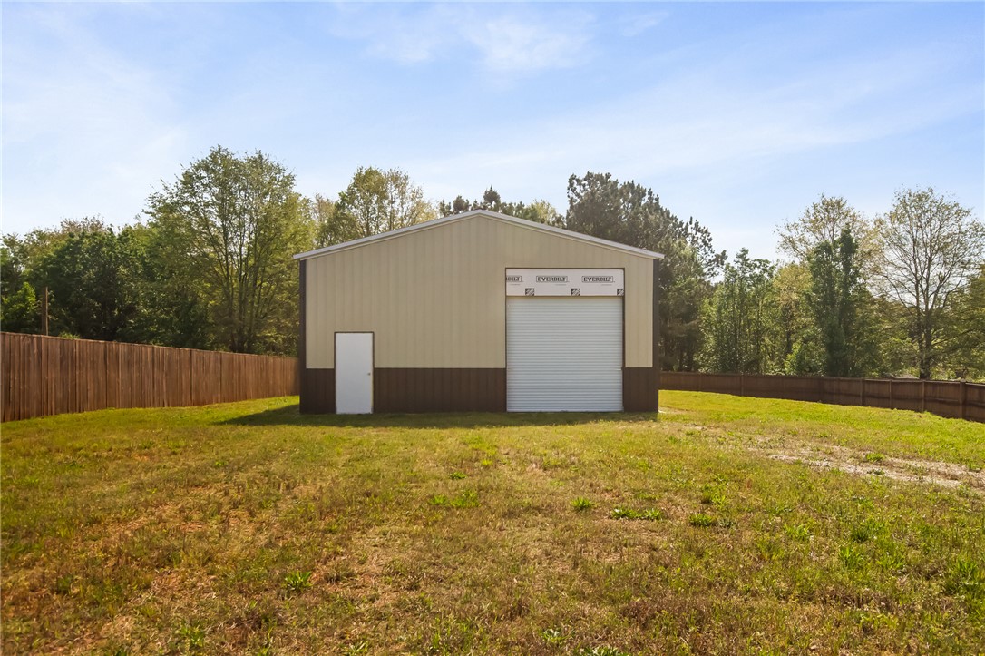 98 Turkey Trot Road Williamston, SC 29697 - Photo 3 of 18 This expansive lot features a durable metal outbuilding, perfect for storage or a workshop, offering versatile possibilities.