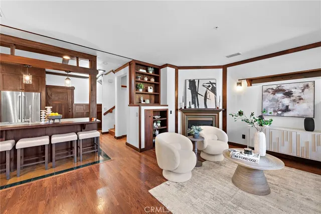 a living room with furniture potted plant and a large window