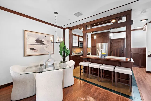 a living room with furniture a wooden floor and a large window