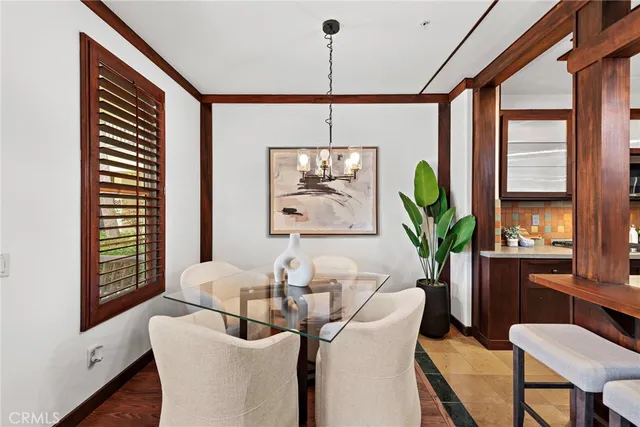 a dining room with furniture a window and a chandelier