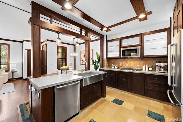 a large kitchen with stainless steel appliances granite countertop a sink and cabinets