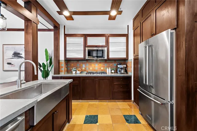 a kitchen with granite countertop a refrigerator and a sink