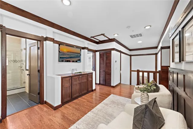 a living room with stainless steel appliances granite countertop furniture a fireplace and a large window