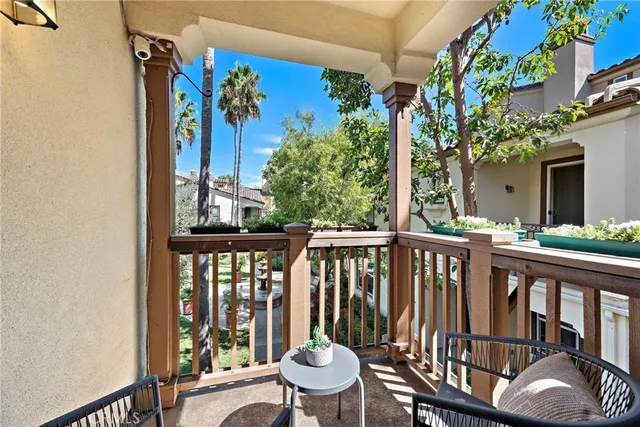 a view of a balcony with chair and wooden floor