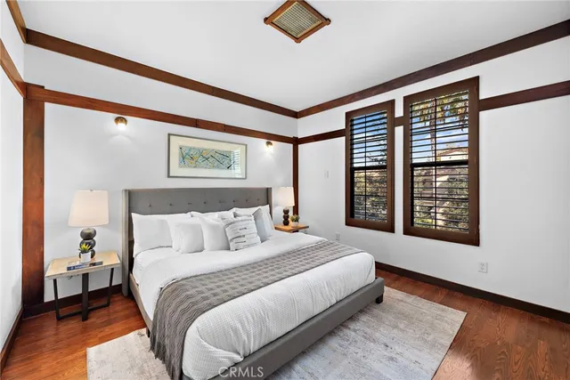 a bedroom with a large bed and a large window