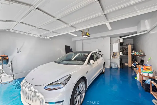 a utility room with furniture a wooden floor and a shower
