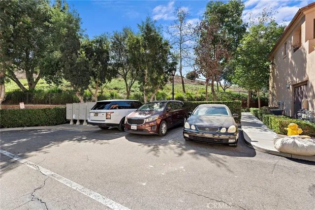 a view of car parked on the side of a street