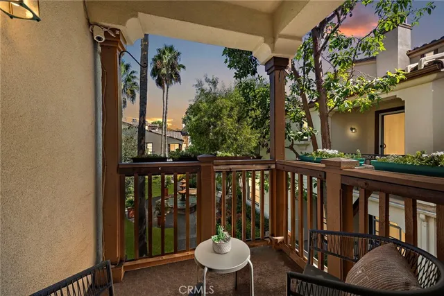 a view of a balcony with chair and wooden floor