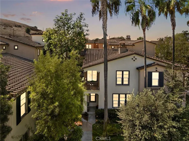 a view of a residential apartment building with a palm tree