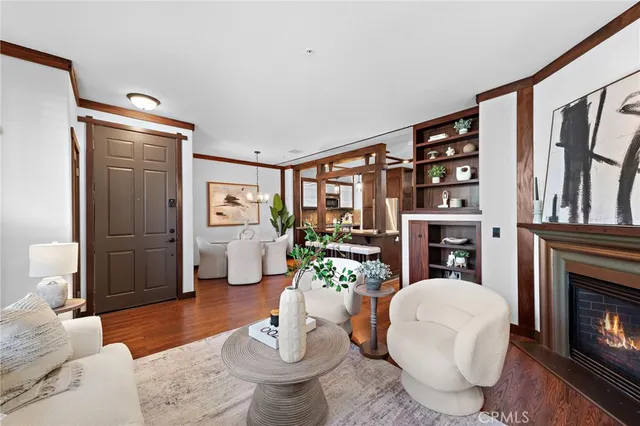 a living room with furniture a fireplace and a large window