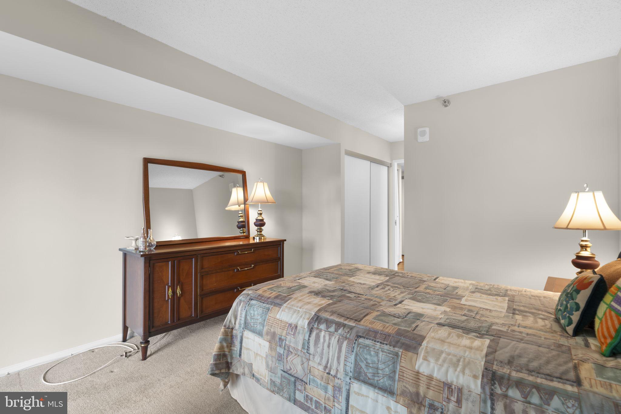 15115 Interlachen Drive, Unit 3204 Silver Spring, MD 20906 - Photo 25 of 50 Cozy bedroom with warm lighting.