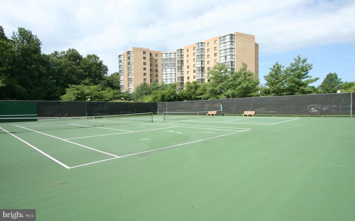 15115 Interlachen Drive, Unit 3204 Silver Spring, MD 20906 - Photo 44 of 50 Serene tennis courts amid greenery.