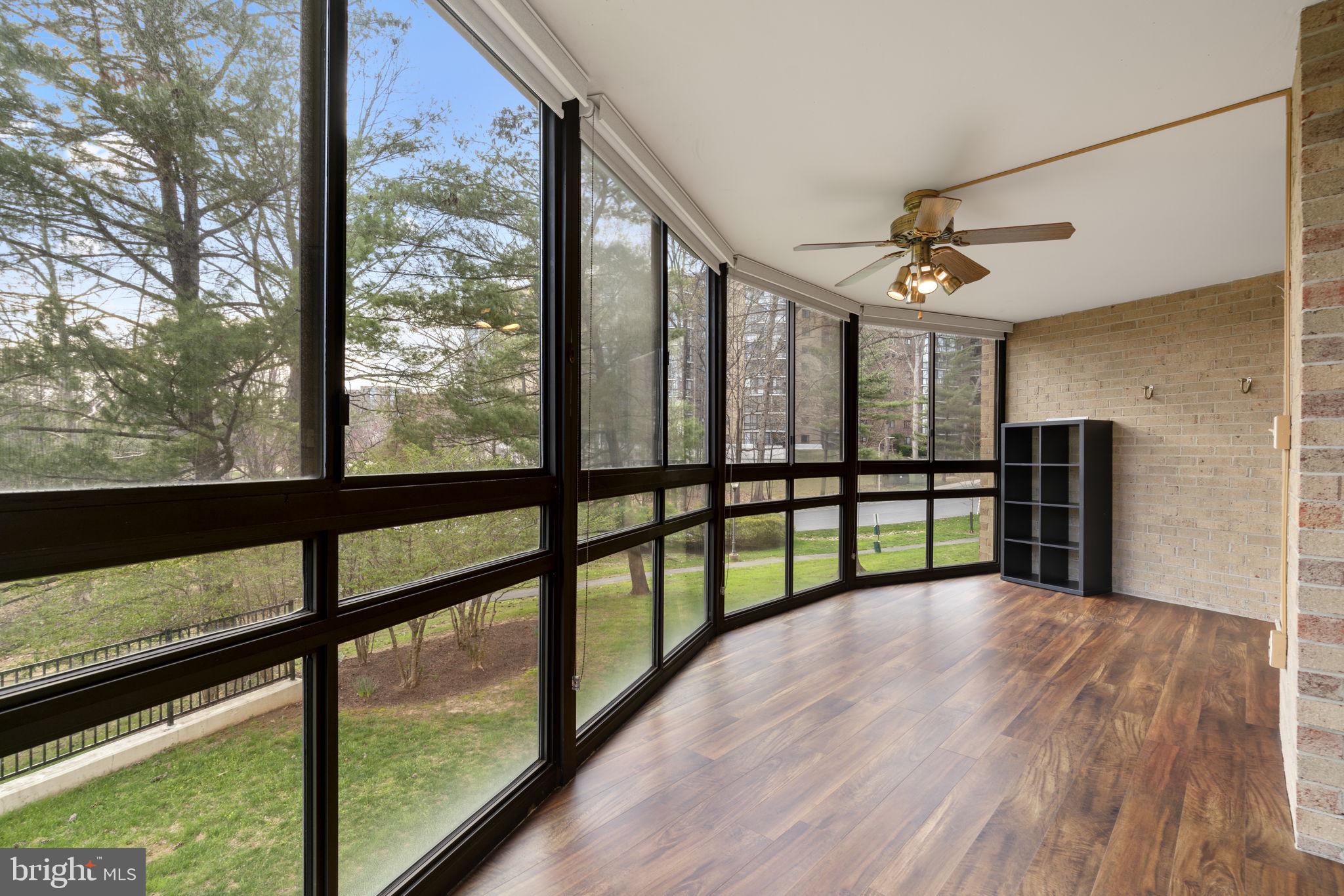 15115 Interlachen Drive, Unit 3204 Silver Spring, MD 20906 - Photo 8 of 50 Sunlit sunroom with scenic views.