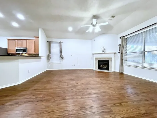 a view of a kitchen with a stove cabinets and wooden floor