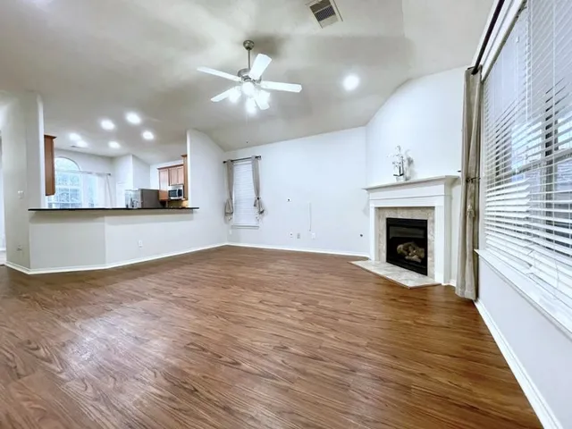 a view of a kitchen with a stove cabinets and wooden floor