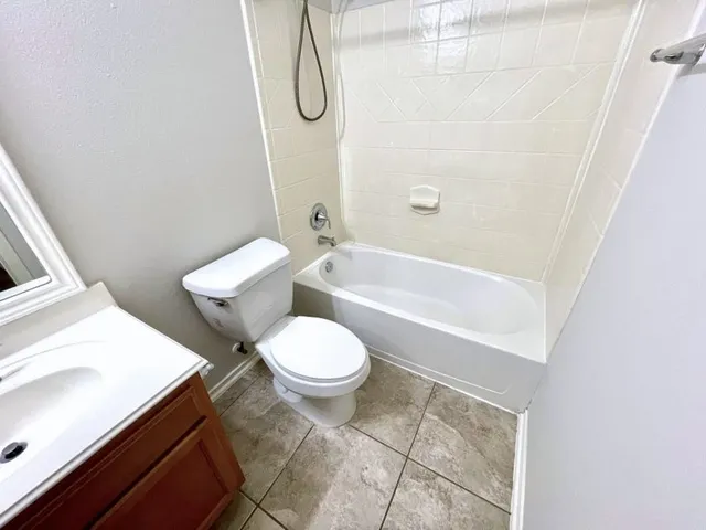 a bathroom with a sink a toilet and a bathtub