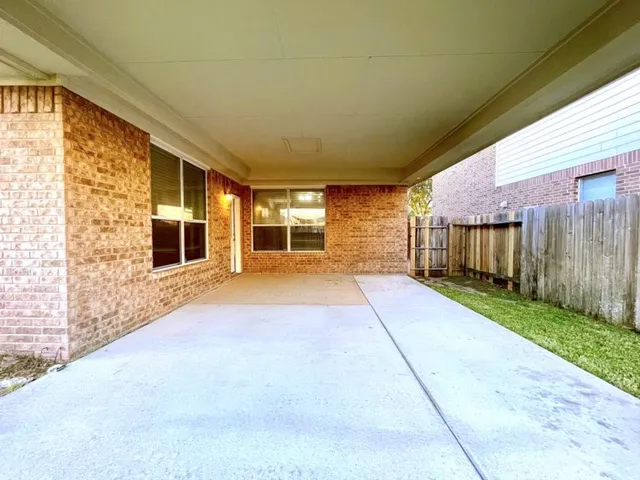 a view of a house with a backyard and floor to ceiling window
