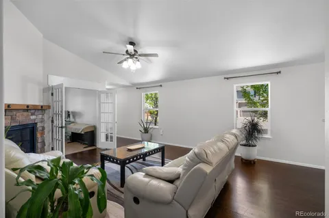 a living room with furniture a fireplace and a potted plant