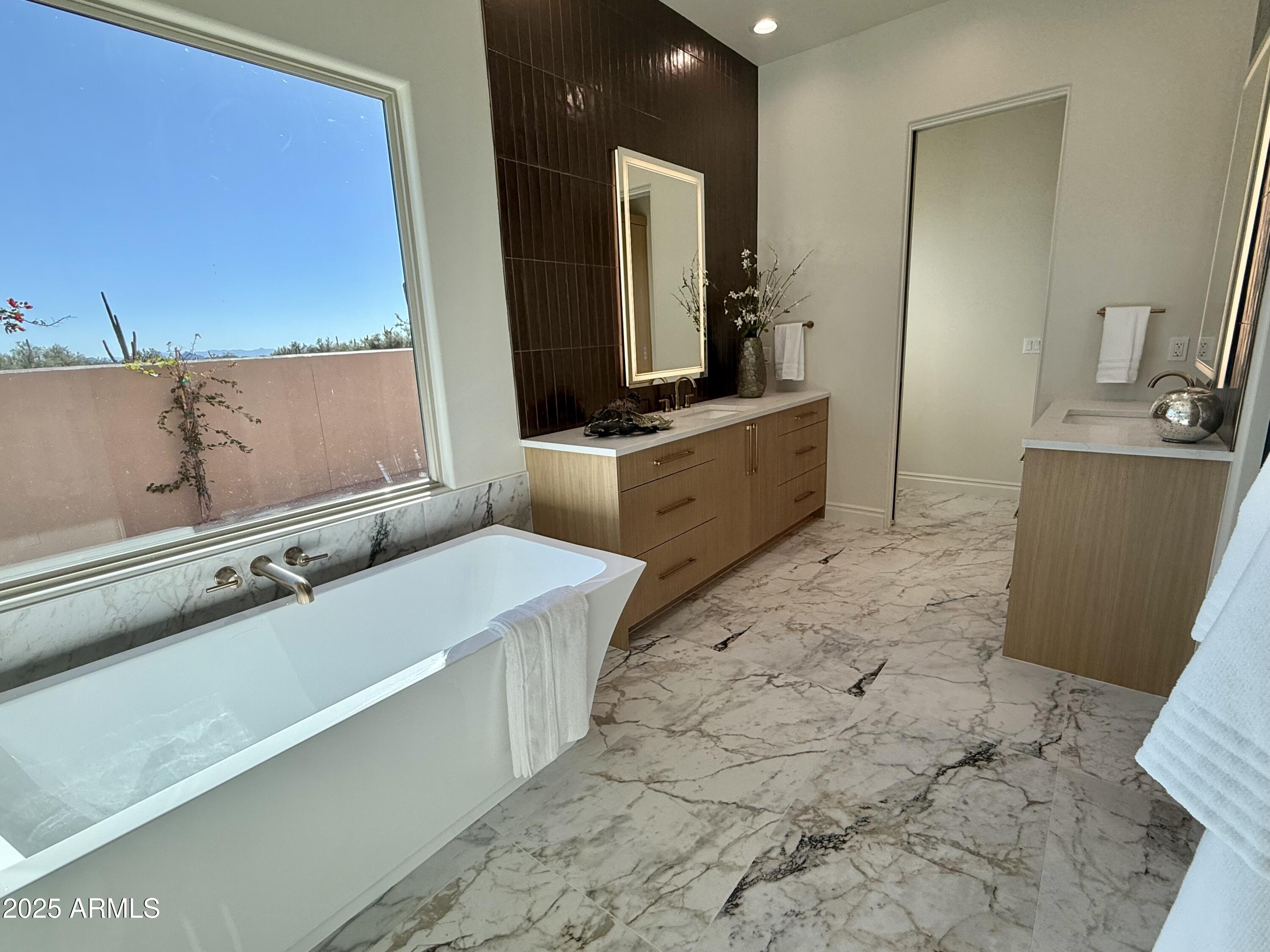27227 North Miller Road Scottsdale, AZ 85266 - Photo 12 of 31 a large bathroom with a large mirror