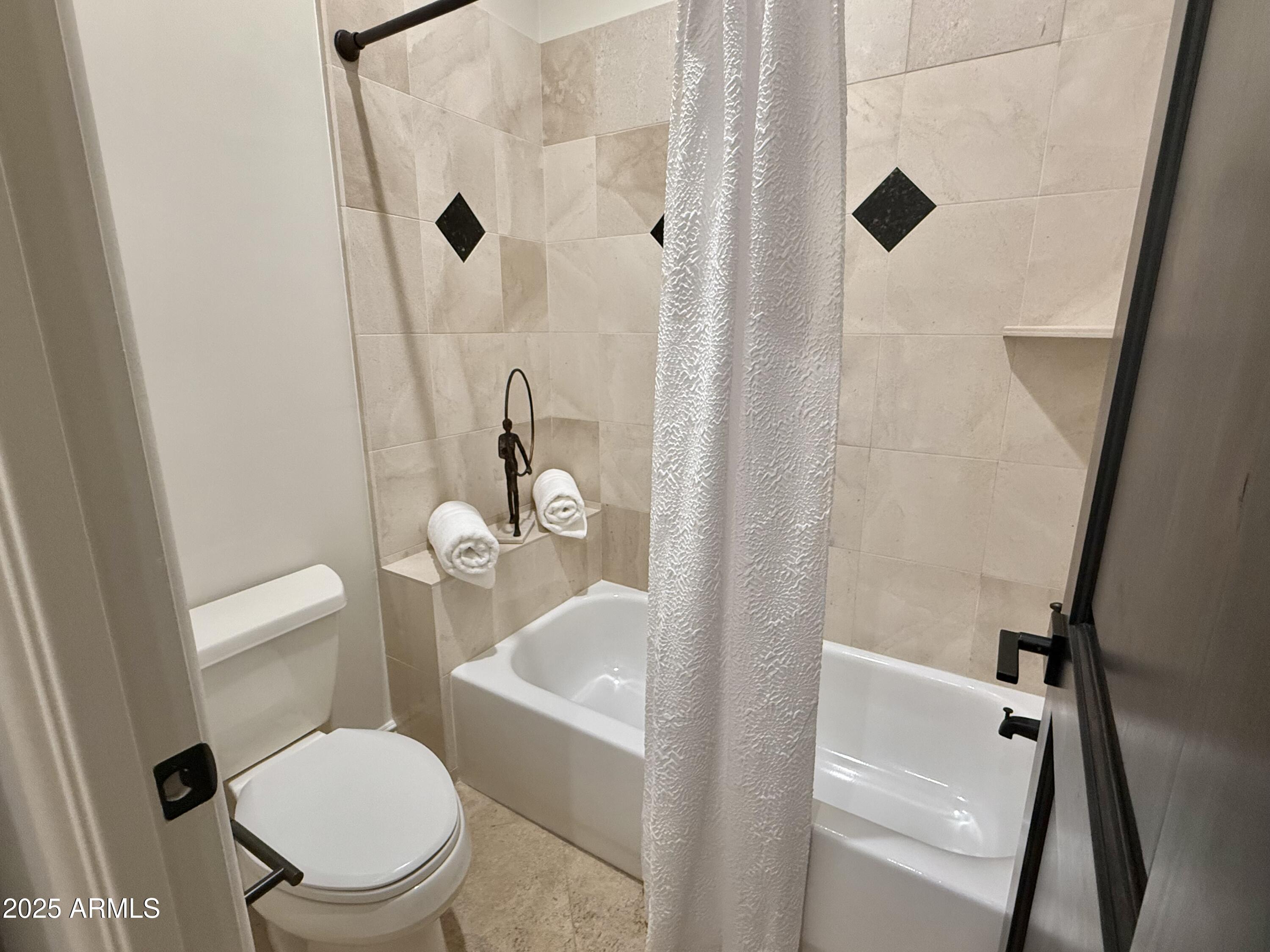 27227 North Miller Road Scottsdale, AZ 85266 - Photo 18 of 31 a white toilet sitting next to a bath tub