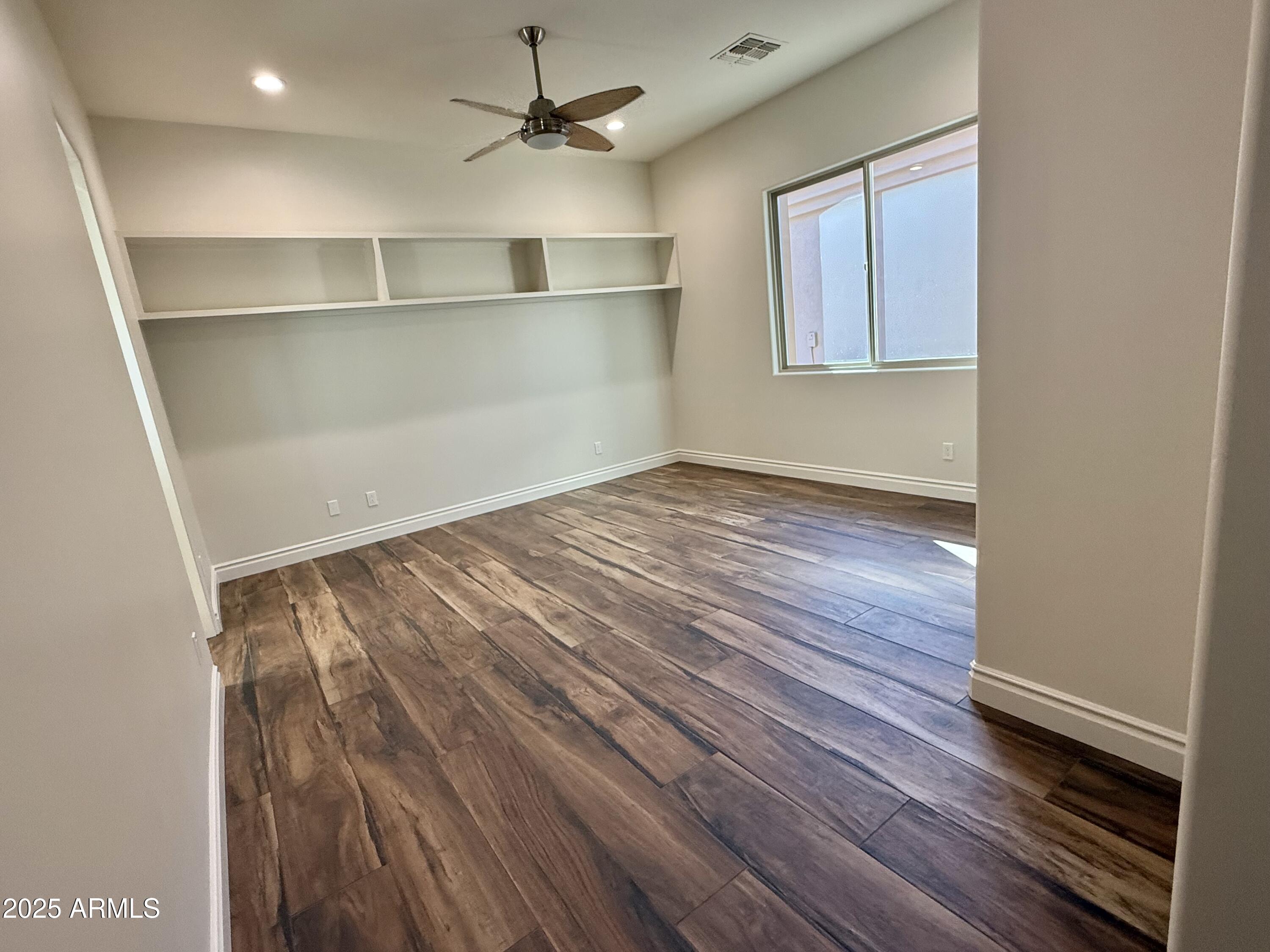 27227 North Miller Road Scottsdale, AZ 85266 - Photo 23 of 31 an empty room with wooden floor closet and windows