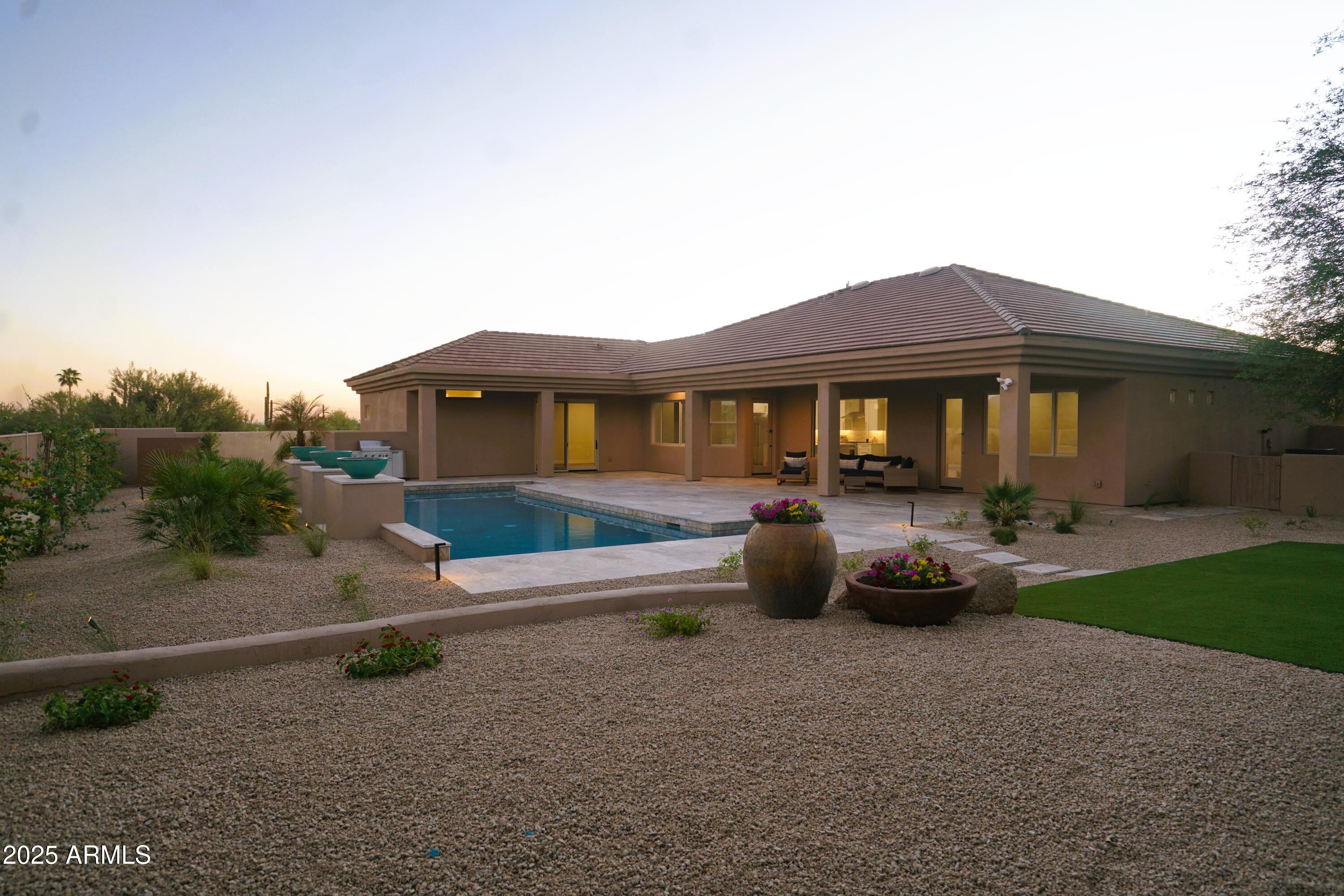 27227 North Miller Road Scottsdale, AZ 85266 - Photo 29 of 31 a front view of a house with a garden