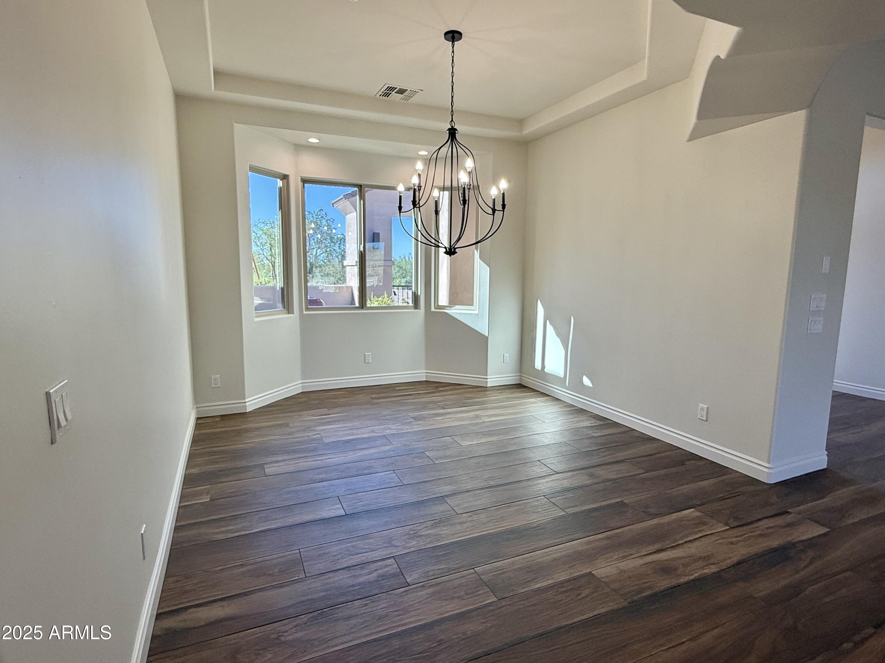 27227 North Miller Road Scottsdale, AZ 85266 - Photo 4 of 31 a view of a room with wooden floor chandelier and entryway