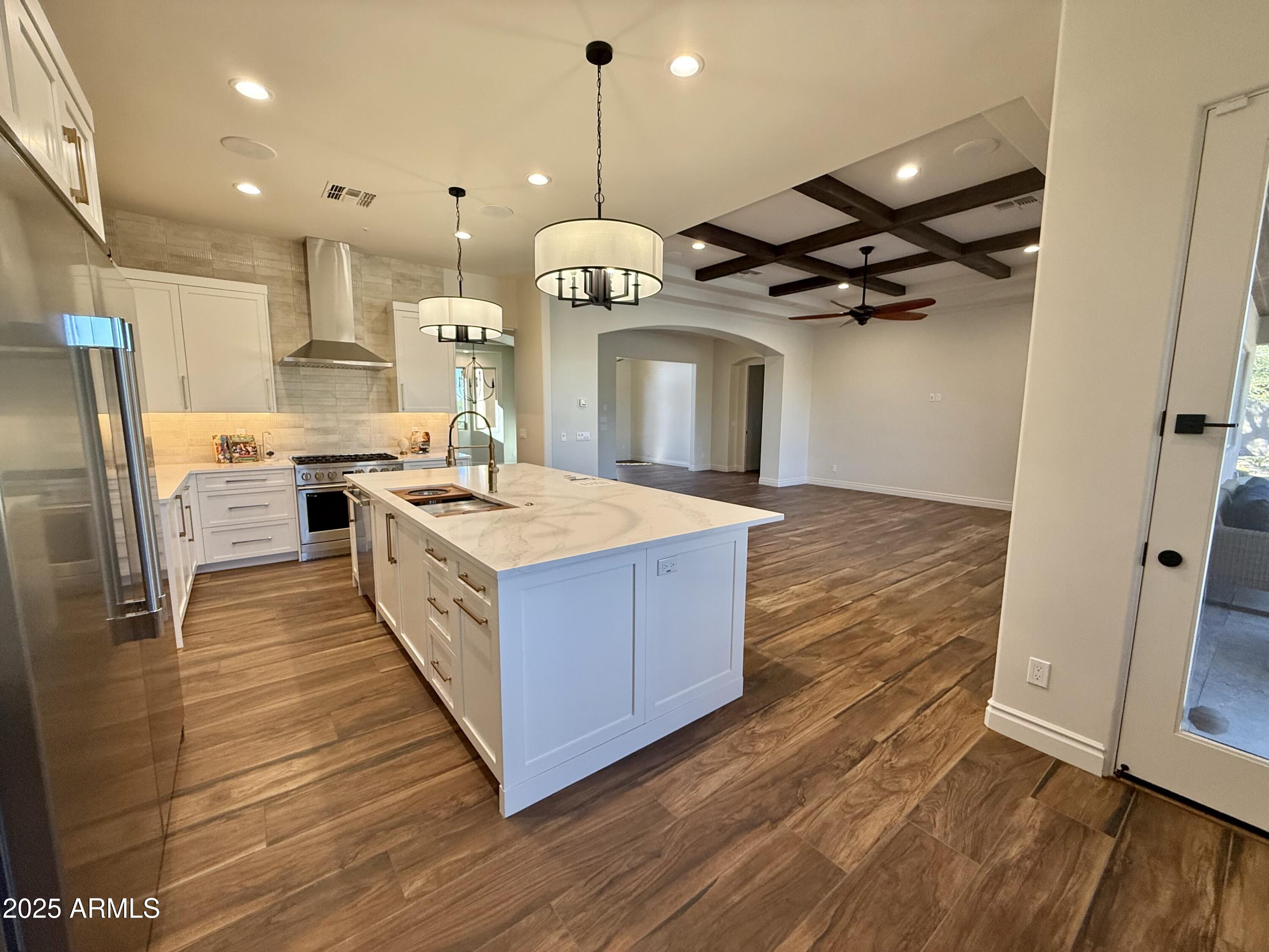 27227 North Miller Road Scottsdale, AZ 85266 - Photo 8 of 31 a kitchen with stainless steel appliances granite countertop a sink refrigerator and wooden floor