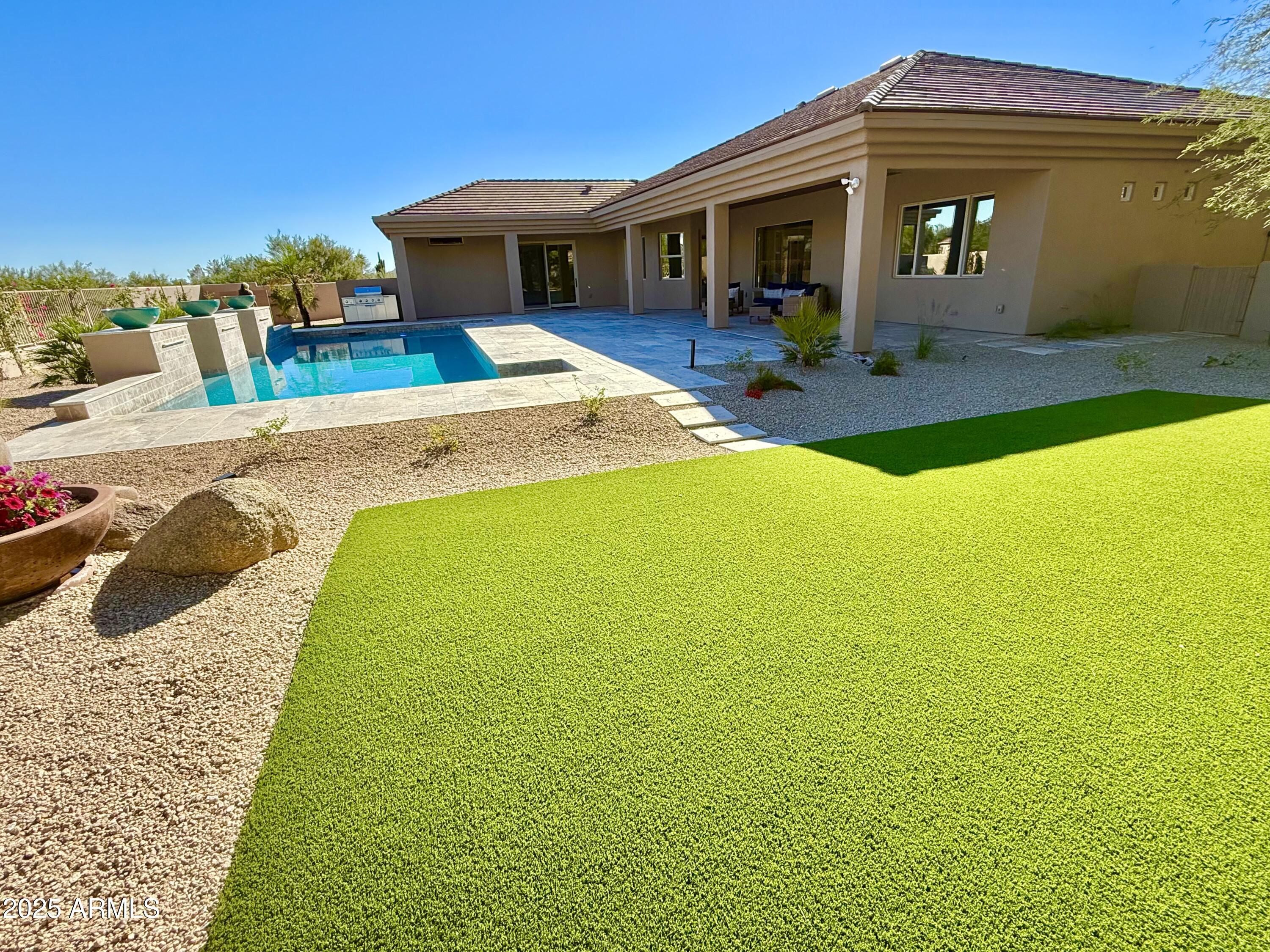 27227 North Miller Road Scottsdale, AZ 85266 - Photo 9 of 31 a front view of a house with yard patio and balcony