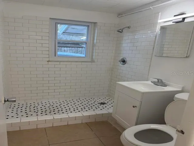 a bathroom with a sink toilet and shower