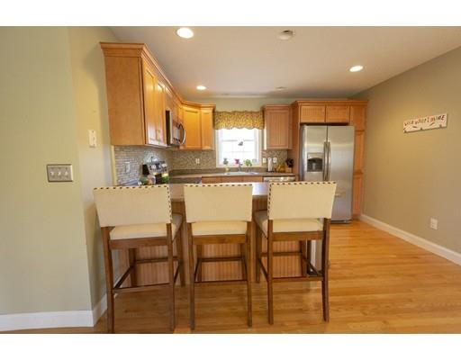 192 Damon Road Ashby, MA 01431 - Photo 4 of 21 a kitchen with stainless steel appliances kitchen island granite countertop a dining table chairs and a refrigerator