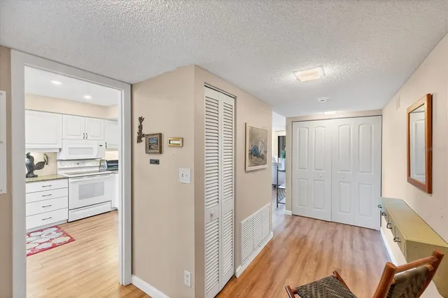 a kitchen with stainless steel appliances granite countertop a sink and a refrigerator