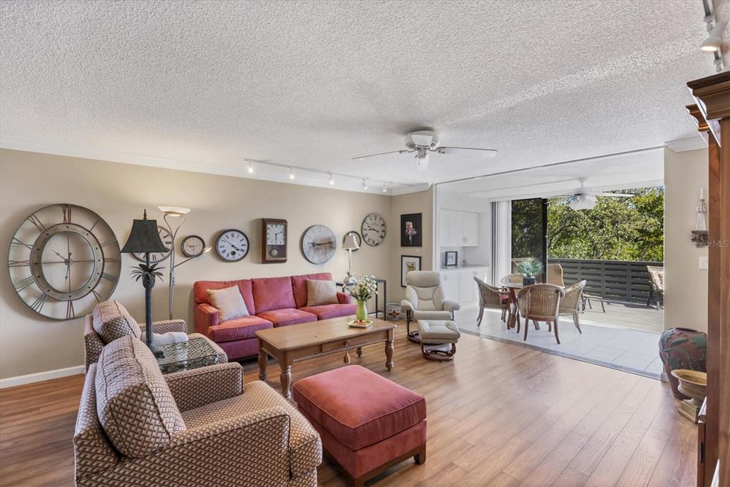825 Bayport Way, Unit 825 Longboat Key, FL 34228 - Photo 22 of 62 a living room with furniture a wooden floor and a large window