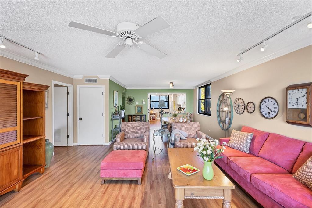 825 Bayport Way, Unit 825 Longboat Key, FL 34228 - Photo 24 of 62 a living room with furniture and wooden floor