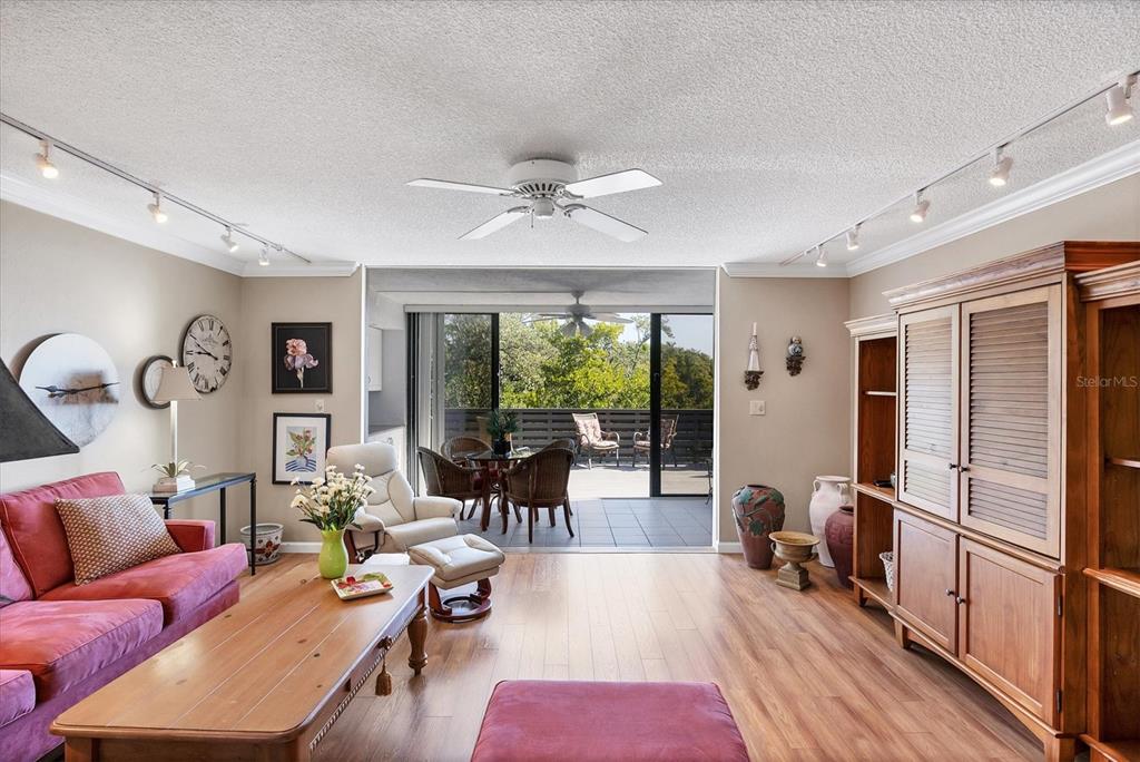 825 Bayport Way, Unit 825 Longboat Key, FL 34228 - Photo 25 of 62 a living room with furniture a large window and wooden floor