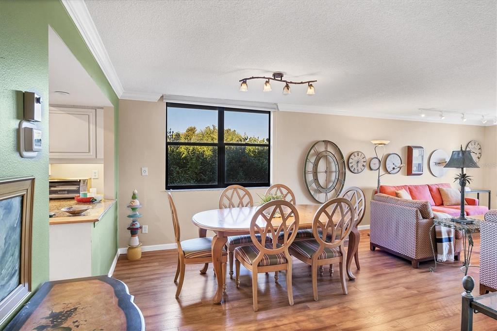 825 Bayport Way, Unit 825 Longboat Key, FL 34228 - Photo 26 of 62 a view of a dining room with furniture window and wooden floor